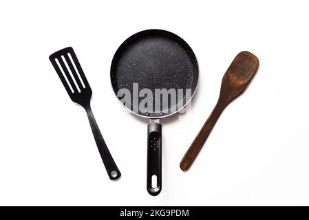 Empty pan on white background. Fried pan with spatula Stock Photo