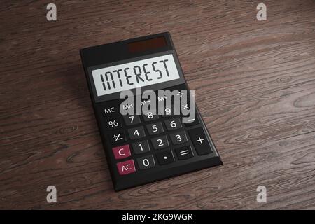 Calculator showing the word Interest. Illustration of the concept of increasing interest rate for loans and mortgage Stock Photo