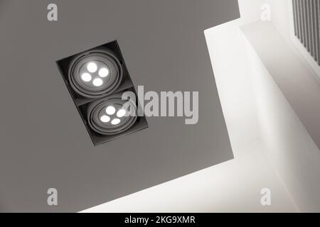 LED spot lights mounted in white  ceiling, modern interior background Stock Photo