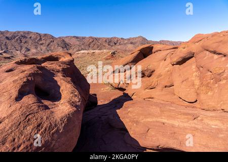 Multicolored red-brown sandstone with signs of weathering and erosion, patterns and textures of rock formation; mountainous landscape Stock Photo