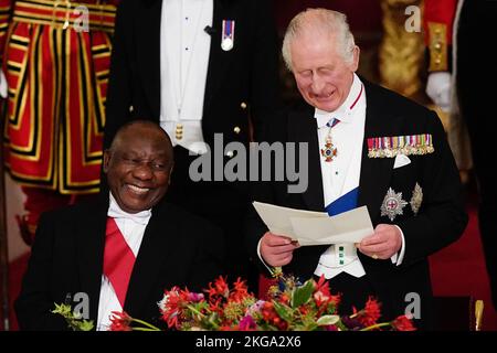 President Cyril Ramaphosa of South Africa, laughs as King Charles III speaks during the State Banquet held at Buckingham Palace, London, during the State Visit to the UK by the South African president. Picture date: Tuesday November 22, 2022. Stock Photo