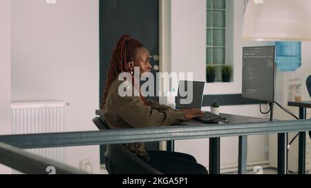 Database programer writing source code and script on terminal window, working with computer displaying coding algorithm. Software developer programming big data in agency office. Stock Photo