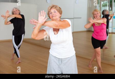 Cheerful senior woman enjoying active dancing in dance studio Stock Photo