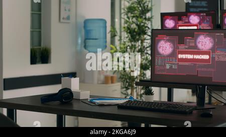 Empty developing office with critical error message flashing on screens, dealing with security breach and hacking attack alert. Multiple monitors showing system crash computer malfunction. Stock Photo