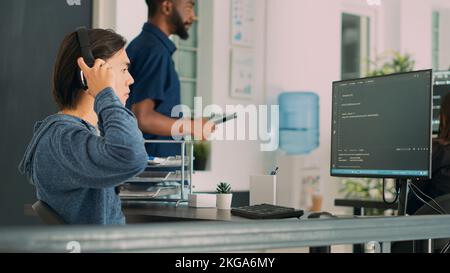 Software engineer working on user interface and writing code with html script, developing cloud computing server. Database admin using algorithms for artificial intelligence. Handheld shot. Stock Photo