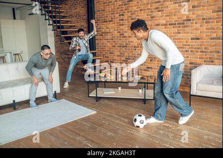 Emotional man cheering for his pals during their sports game Stock Photo