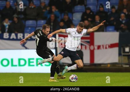 Barrow's Josh Kay in action with Bolton Wanderers' Dion Charles during the EFL Trophy Round of 32 match between Bolton Wanderers and Barrow at the University of Bolton Stadium, on Tuesday 22nd November 2022 in Bolton, England. (Photo by: Mark Fletcher | MI News) Credit: MI News & Sport /Alamy Live News Stock Photo