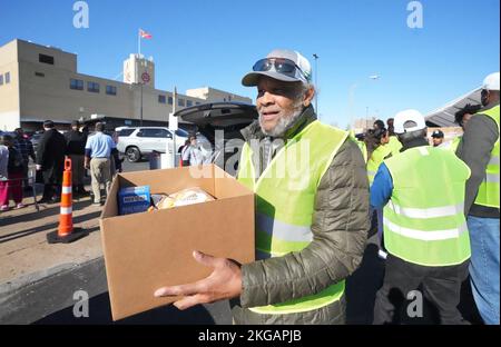 St. Louis, United States. 22nd Nov, 2022. Former St. Louis Football Cardinals and National Football Hall of Fame member Johnny Roland, carries a box of food supplies to a waiting car during the Thanksgiving food give-a-way at the Urban League of Greater St. Louis in St. Louis on Tuesday, November 22, 2022. Roland joined several other former NFL football players that live in the area, to pass out over 2500 Thanksgiving turkeys and all of the fixings to those in need. Photo by Bill Greenblatt/UPI Credit: UPI/Alamy Live News Stock Photo