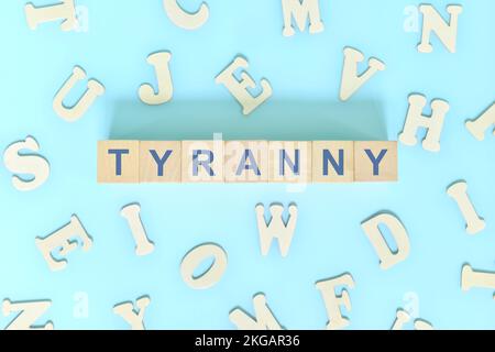 Tyranny government form concept. Wooden blocks typography flat lay in blue background. Stock Photo