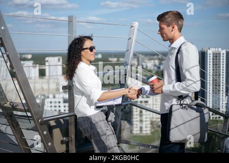 young business colleagues greet each other in the business center. Stock Photo