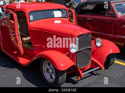 NISSWA, MN – 30 JUL 2022: Customized red hot street rod with custom design, with open suicide doors, headlights, grille and hood, at a car show. Stock Photo