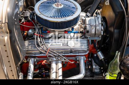 NISSWA, MN – 30 JUL 2022: Closeup image of the engine compartment of a street rod at a car show, with air filter, spark plugs, cylinder head cover and Stock Photo