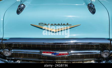 NISSWA, MN – 30 JUL 2022: Front end of a 57 Chevy Bel Air car, with Chevrolet logo, hood rockets and grille, in closeup view. Stock Photo