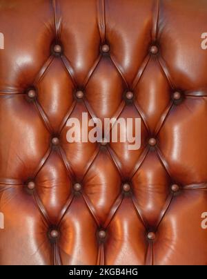 Brown leather material upholstery pattern background used in furniture industry Stock Photo