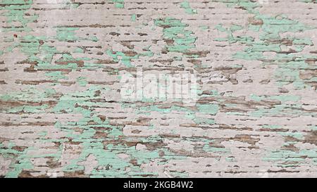 Wooden surface is covered with old multicolored peeling paint. Top view Stock Photo