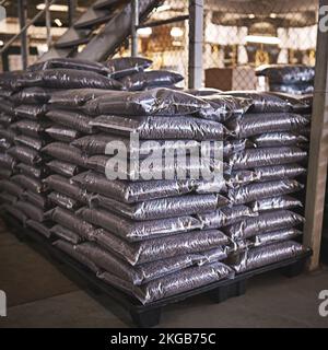 All ready for shipment. a bags of coffee beans on the floor of a distribution warehouse. Stock Photo