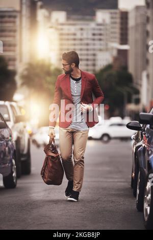 Making my way down town. Full length shot of a stylish young man walking through the city. Stock Photo