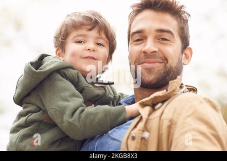 Alike in so many ways. a father and son enjoying a day outdoors. Stock Photo