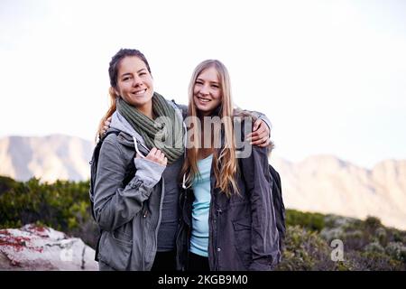 We made it together. Portrait of two attractive young female hikers in the outdoors. Stock Photo