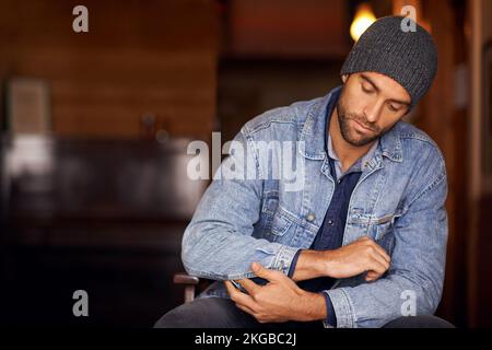 The world is full of guys, be a man. a handsome young man wearing denim clothing. Stock Photo