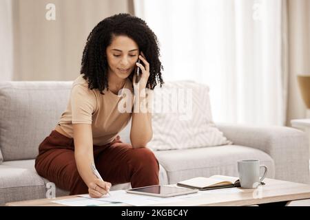 Phone call, documents and writing with a woman freelancer remote working from home on her startup business. Communication, coffee and technology with Stock Photo