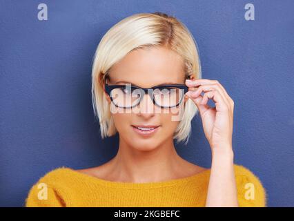 Howd you like my specs. Studio portrait of an attractive young woman wearing glasses. Stock Photo