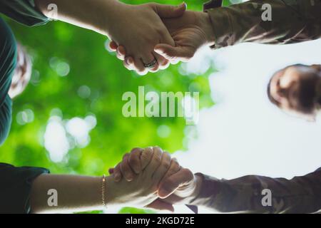 Close up people holding hands concept photo Stock Photo