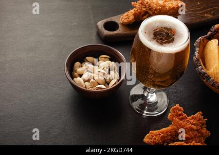bottle of beer and different snacks on rustic wooden table. Top view. High quality photo Stock Photo