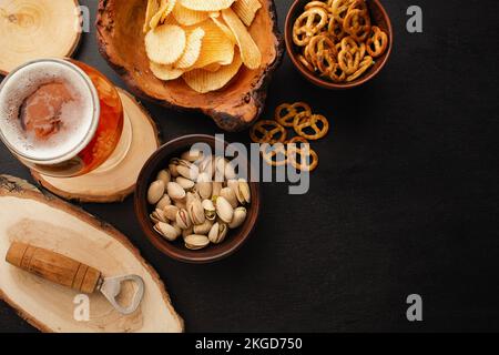 bottle of beer and different snacks on rustic wooden table. Top view. High quality photo Stock Photo