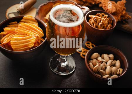bottle of beer and different snacks on rustic wooden table. Top view. High quality photo Stock Photo