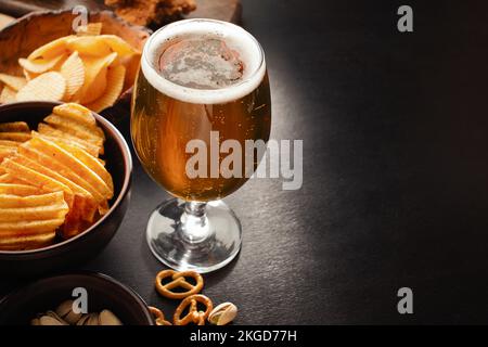 bottle of beer and different snacks on rustic wooden table. Top view. High quality photo Stock Photo
