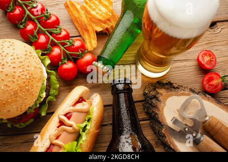 bottle of beer and different snacks on rustic wooden table. Top view. High quality photo Stock Photo