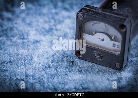 Amperemeter on scratched metallic background vintage electricity concept. Stock Photo