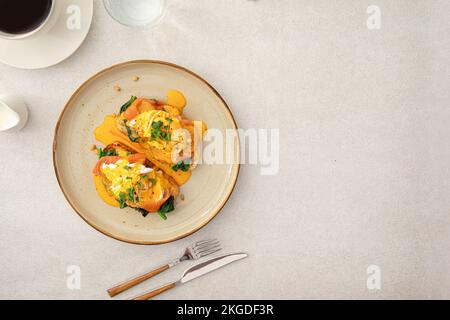 Portion of eggs benedict toast with salmon Stock Photo