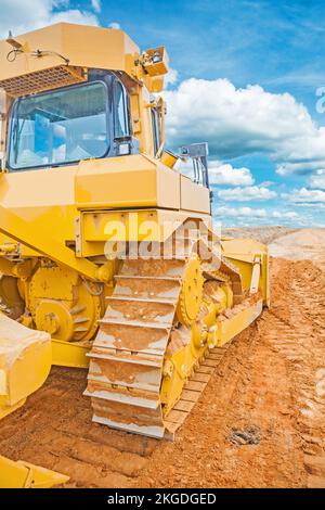 bulldozer standing on sand in construction site rear view Stock Photo