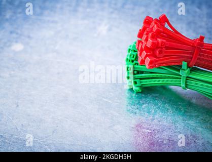 Bunch of self-locking cable ties on metallic background construction concept. Stock Photo