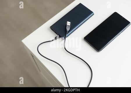 Power bank for charging mobile devices. Smartphone charger. External battery for mobile devices. Stock Photo