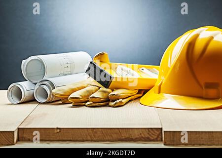 construction blueprints gloves level helmet Stock Photo