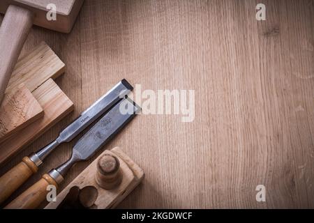 Copy space image of lump hammer planer metal firmer chisels and wooden stud on wood board construction concept. Stock Photo