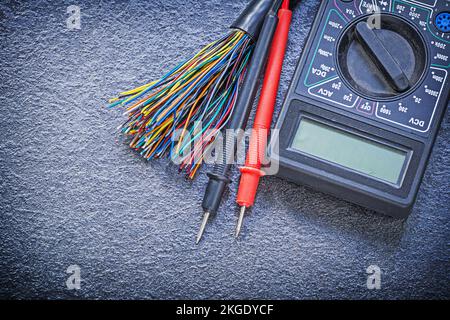 Digital multimeter electrical tester cables on black background electricity concept. Stock Photo