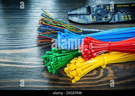 Electric wires tying cables bolt cutter on wooden board. Stock Photo