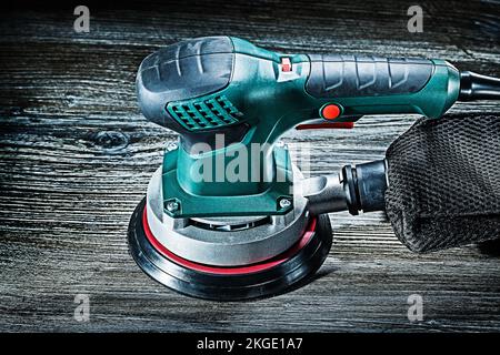 electric wood sander on vintage gray wooden background Stock Photo