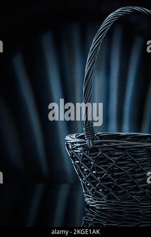 empty wicker basket on abstract black background Stock Photo