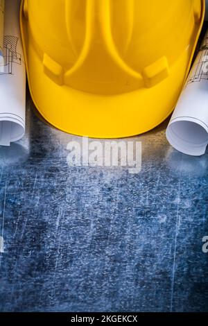 Pair of construction plans and hard hat on metallic background building and architecture concept. Stock Photo