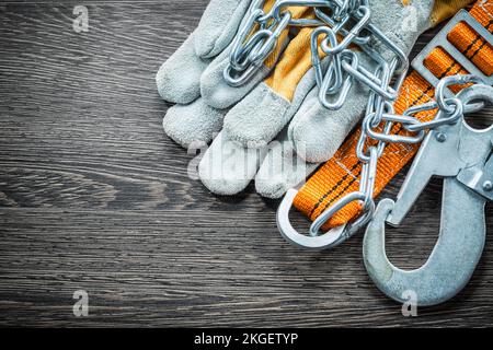 Protective gloves safety belt on wooden board. Stock Photo