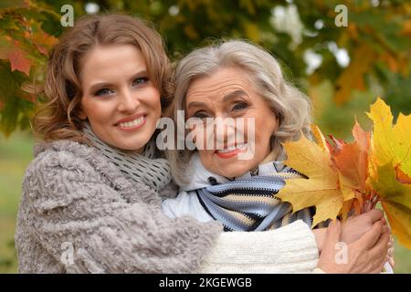 Portrait of an elderly woman with her daughter in autumn. Stock Photo