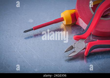 Red insulating tape nippers insulated screwdriver construction concept. Stock Photo