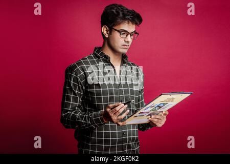 Business Accounts Auditor Conducting Quality Control Professional Businessman Writing on Clipboard in Corporate Office SettingMale auditor inspector Stock Photo