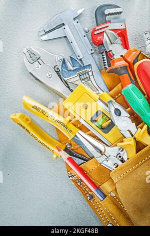 Set of construction tooling in leather tool belt. Stock Photo