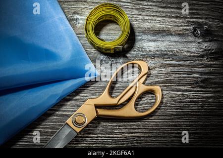sewing tools scissors measure tape on vintage wood Stock Photo